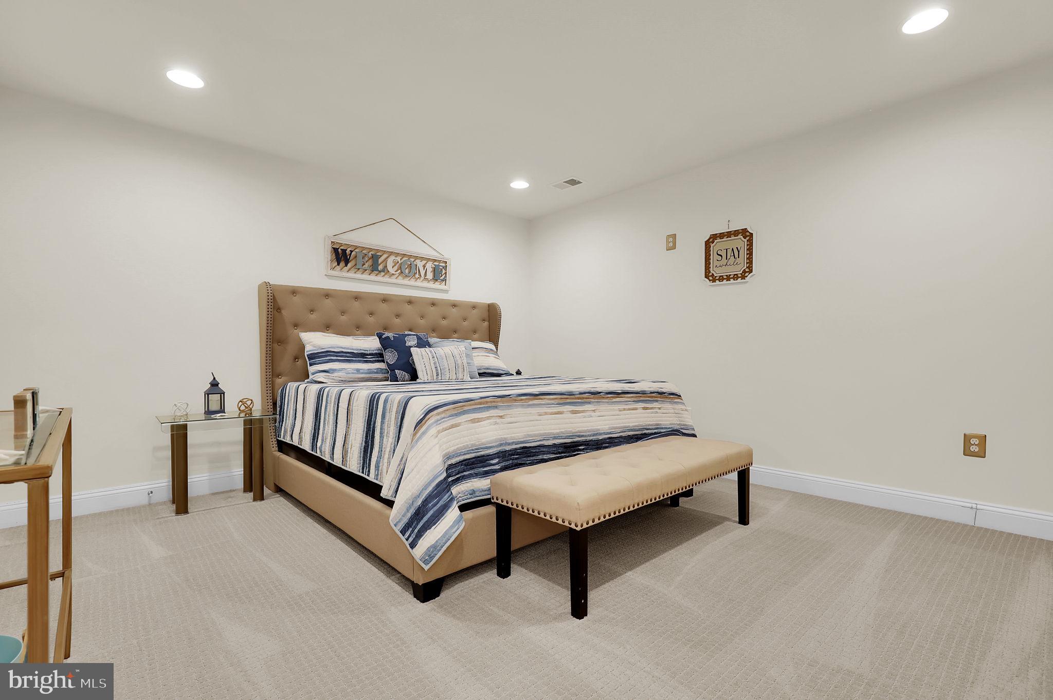 1305 Moore Spring Court Brunswick, MD 21716 - Photo 30 of 64 a bedroom with a bed and a table