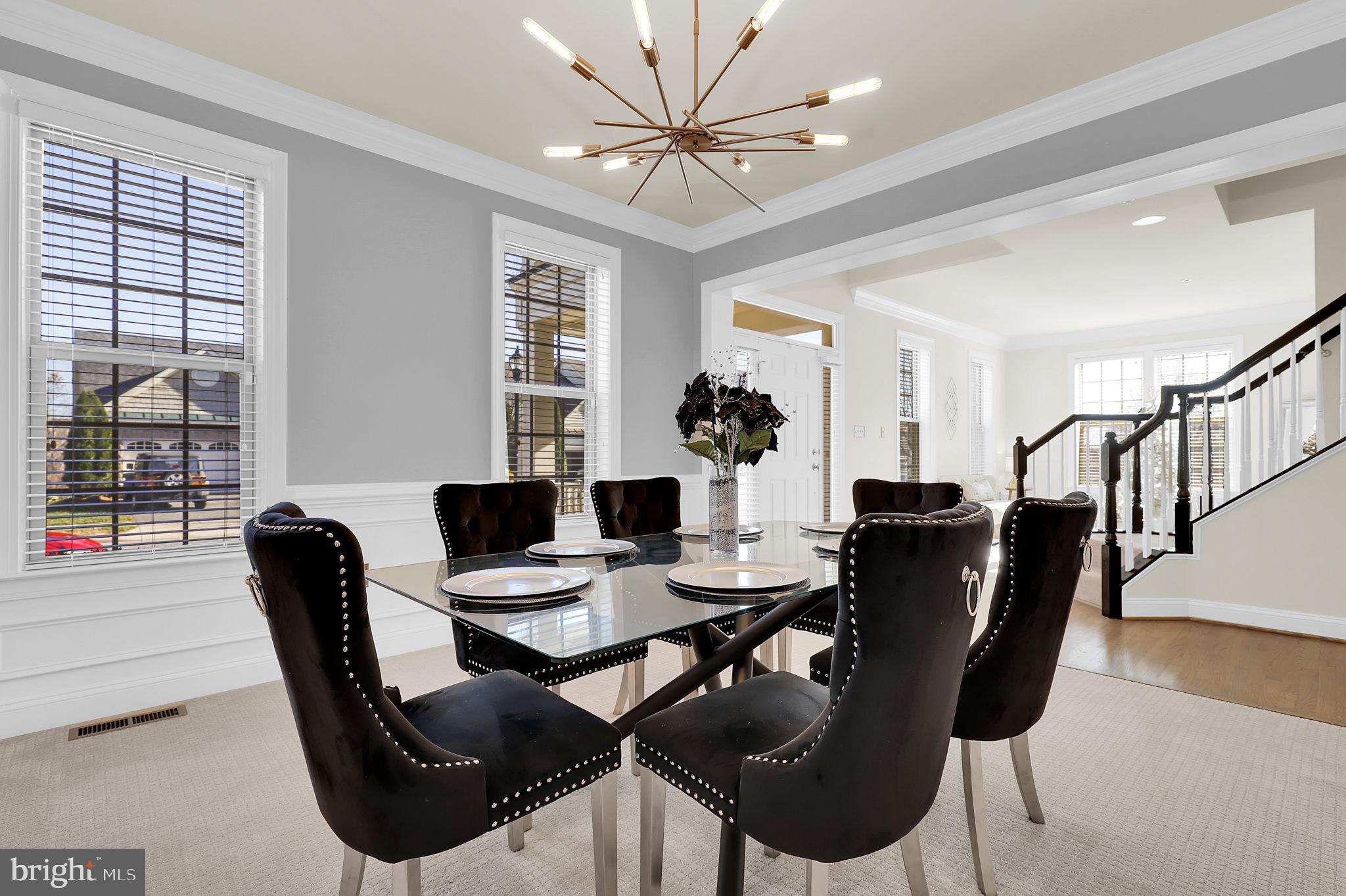 1305 Moore Spring Court Brunswick, MD 21716 - Photo 5 of 64 a view of a dining room with furniture and wooden floor