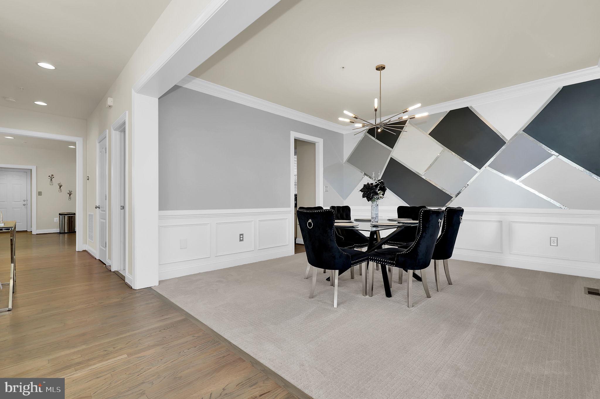 1305 Moore Spring Court Brunswick, MD 21716 - Photo 6 of 64 a view of a dining room with furniture and chandelier