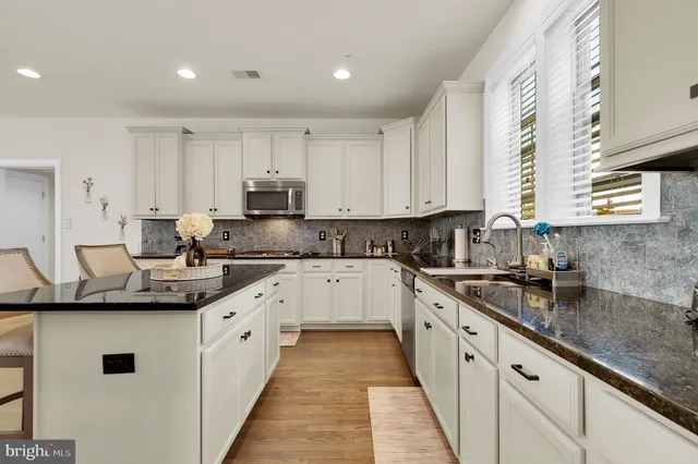 a kitchen with granite countertop a refrigerator and a stove