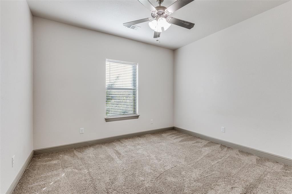 1029 Sunflower Paradise, TX 76073 - Photo 16 of 38 an empty room with a chandelier fan and windows