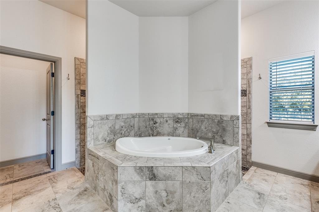 1029 Sunflower Paradise, TX 76073 - Photo 23 of 38 a bathroom with a tub and shower