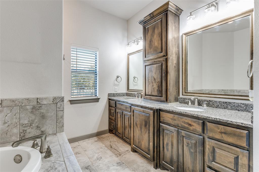 1029 Sunflower Paradise, TX 76073 - Photo 24 of 38 a spacious bathroom with a granite countertop sink a mirror and a