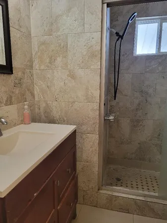 a bathroom with a toilet sink and shower