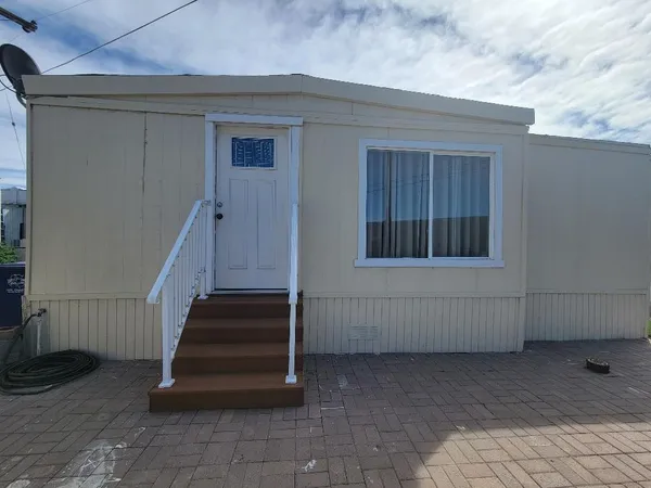a view of a house with a wooden deck