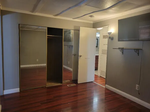 a view of room with wooden floor and stairs