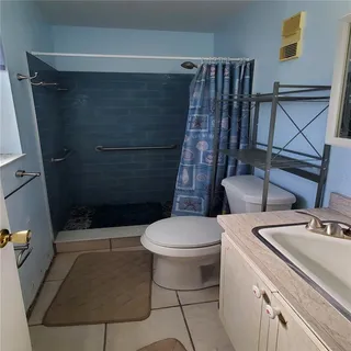 a bathroom with a toilet and a shower