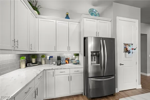 a kitchen with stainless steel appliances a refrigerator sink and cabinets