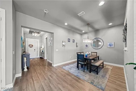 a view of a dining room with furniture and wooden floor