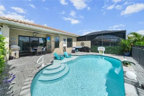 a view of a swimming pool with outdoor seating