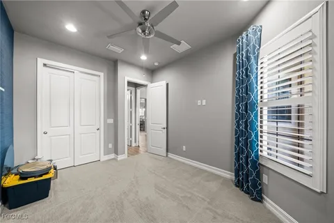 a view of a livingroom with a staircase and kitchen view