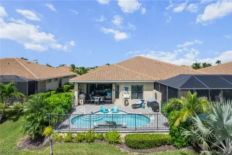 a view of house with a yard and potted plants