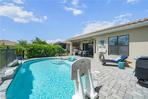 a swimming pool with outdoor seating and yard