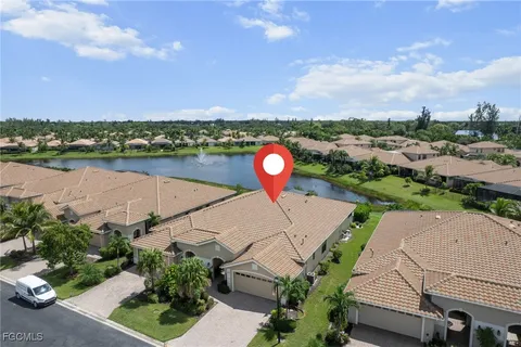 an aerial view of a house with a lake view