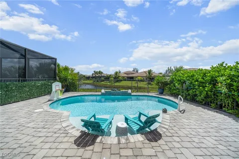 a view of a swimming pool and lounge chair