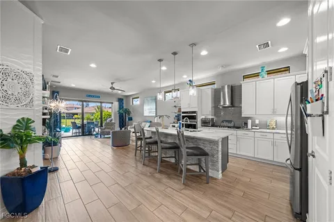 a large kitchen with lots of counter space and furniture