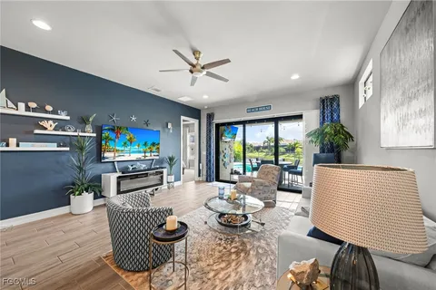 a living room with fireplace furniture and a flat screen tv