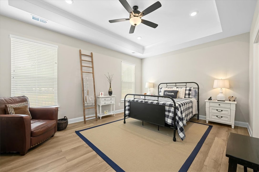 6834 Midway Road Pelzer, SC 29669 - Photo 22 of 50 This inviting bedroom offers comfort and style with its attractive flooring and appealing ceiling design.