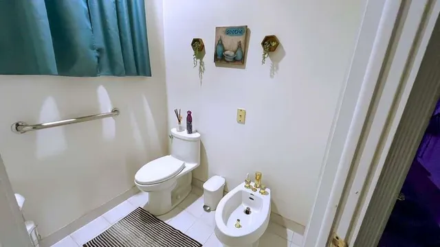a white toilet sitting next to a bathroom sink