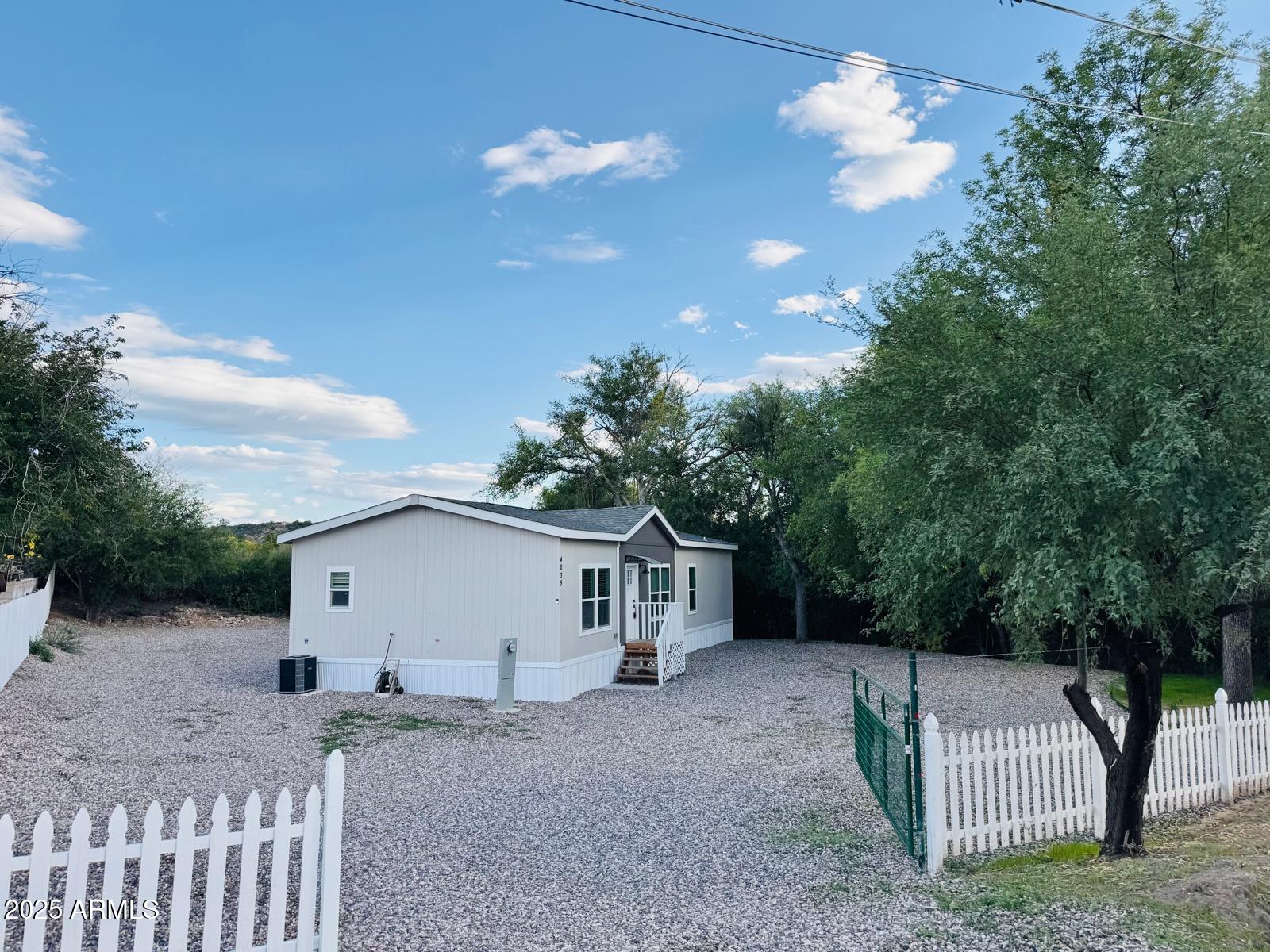 4035 East Goldmine Road Rimrock, AZ 86335 - Photo 3 of 40 a view of a house with a backyard and trees