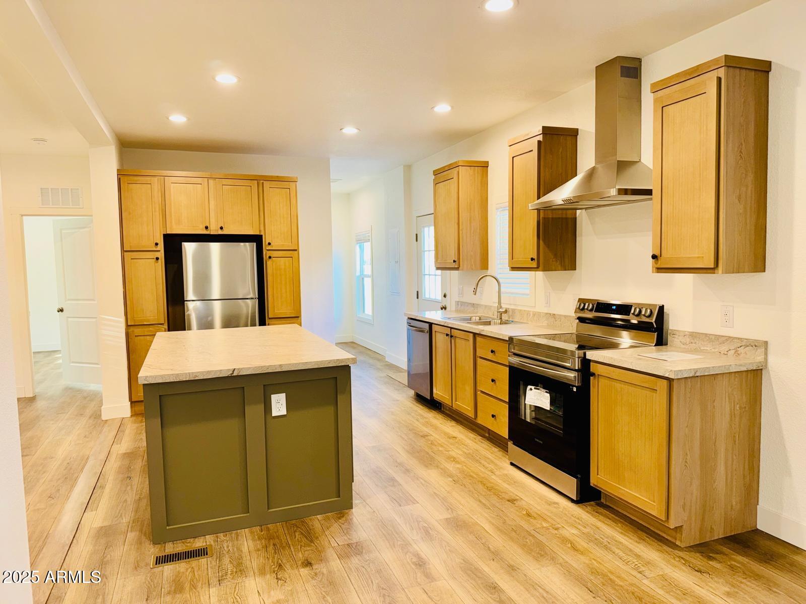 4035 East Goldmine Road Rimrock, AZ 86335 - Photo 8 of 40 a kitchen with stainless steel appliances granite countertop a stove a sink and a refrigerator