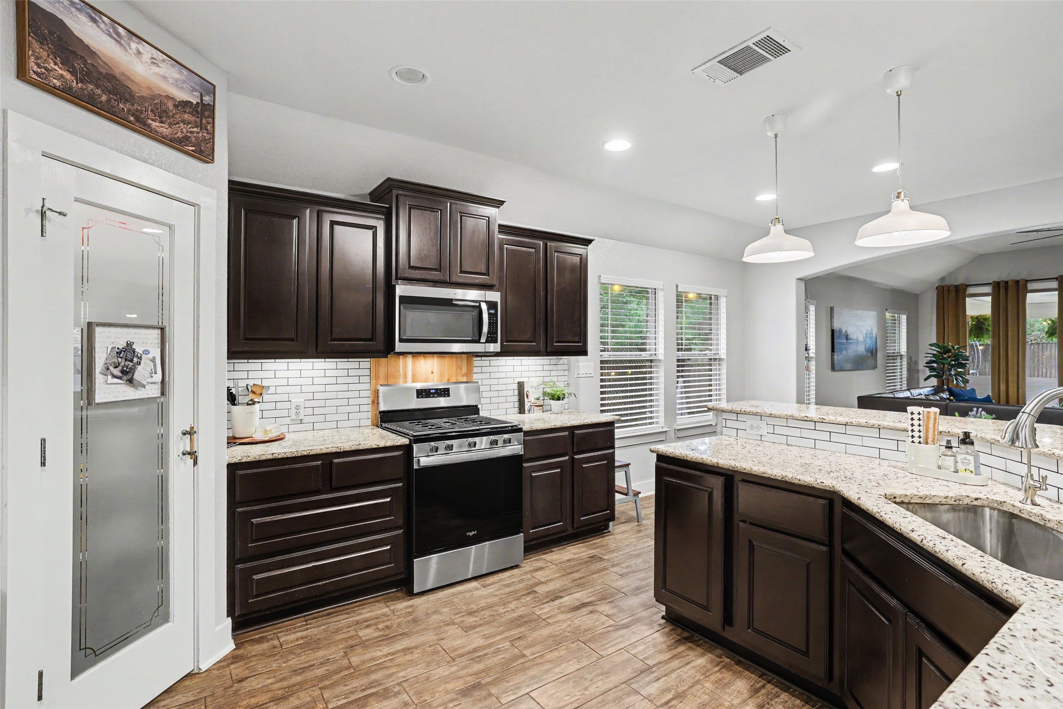 117 Rock Dock Road Georgetown, TX 78633 - Photo 37 of 38 a kitchen with stainless steel appliances granite countertop a sink stove and refrigerator