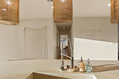 a kitchen with stainless steel appliances kitchen island granite countertop a sink and cabinets