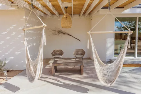 a building outdoor space with patio furniture and potted plants