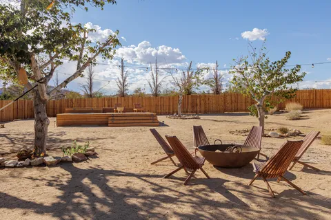 a view of a backyard with swimming pool
