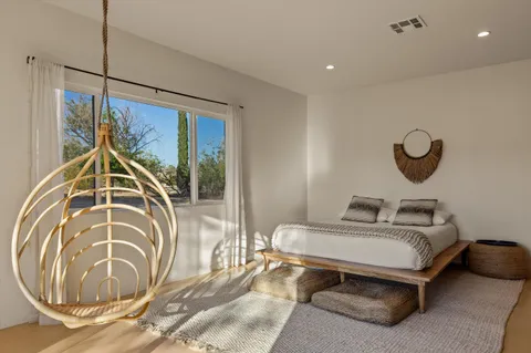 a bedroom with furniture and wooden floor