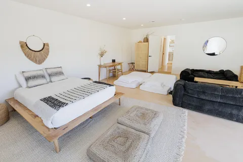 a bedroom with a bed and wooden floor