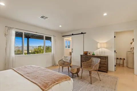 a bedroom with a bed and a couch