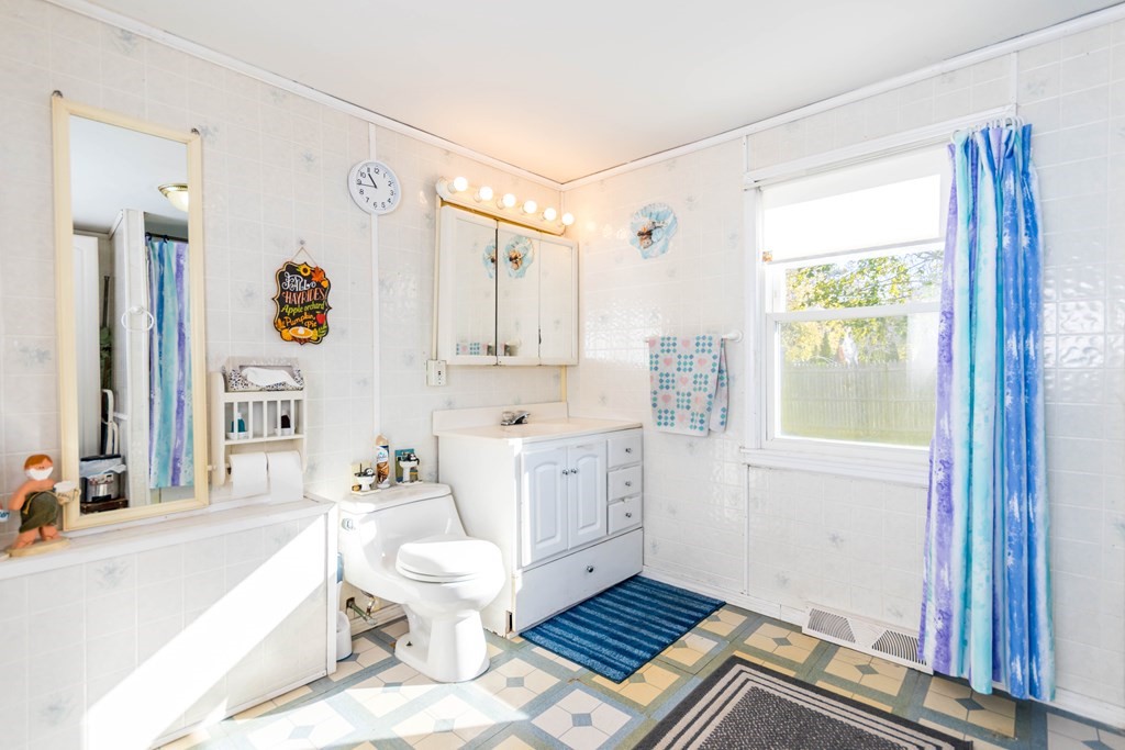 16 Blueberry Road Bourne, MA 02532 - Photo 12 of 22 a bathroom with a sink a toilet a mirror and shower