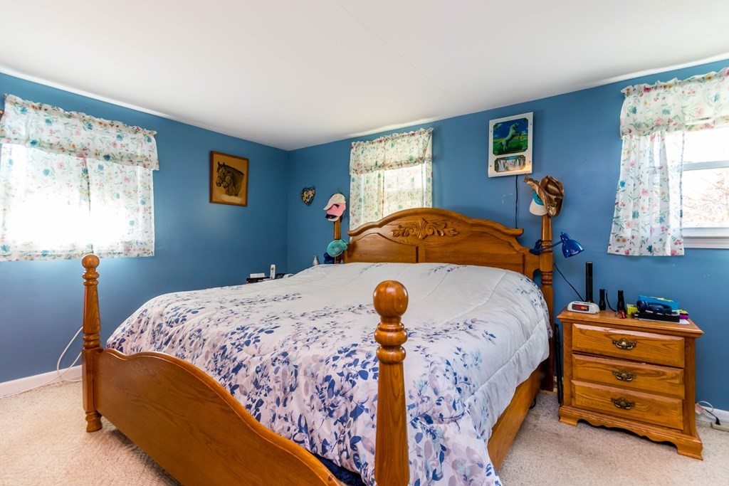 16 Blueberry Road Bourne, MA 02532 - Photo 14 of 22 a bedroom with a bed and a window