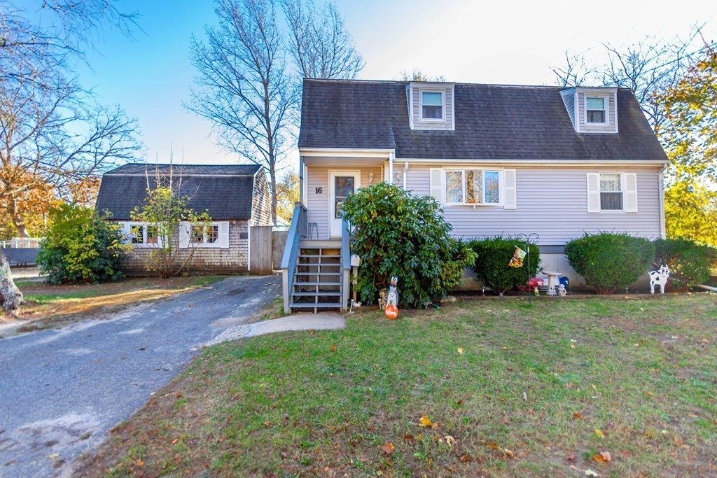 16 Blueberry Road Bourne, MA 02532 - Photo 19 of 22 a view of a brick house with a yard and plants