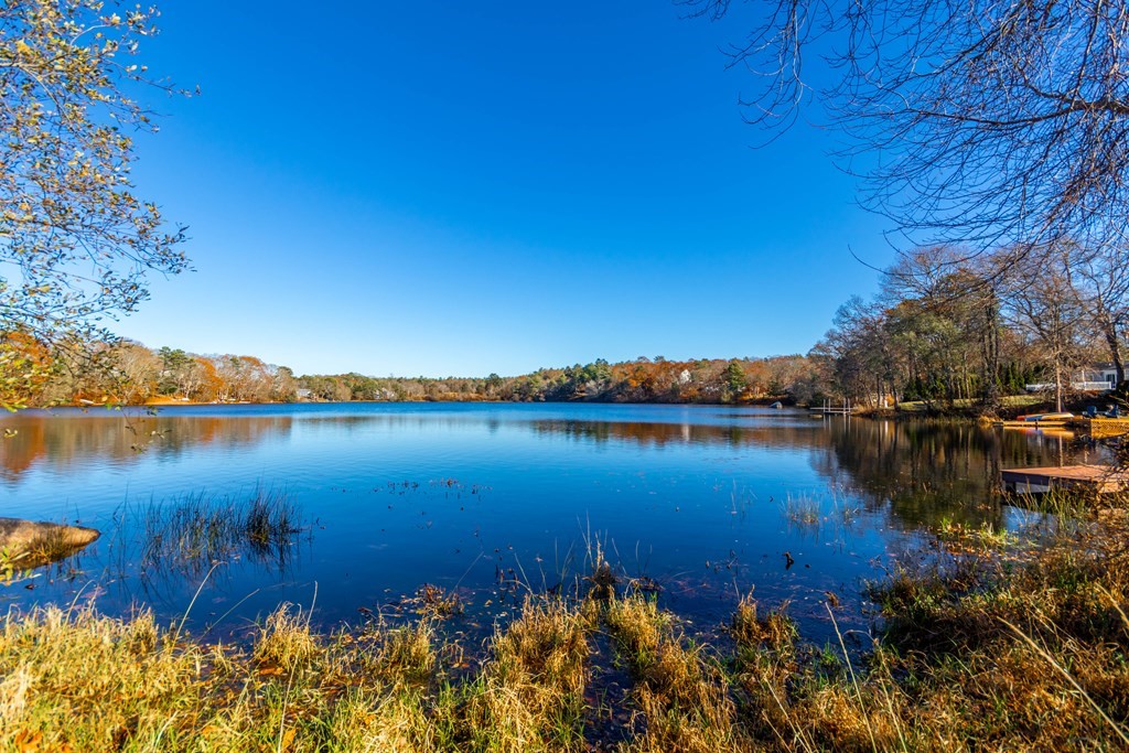 16 Blueberry Road Bourne, MA 02532 - Photo 3 of 22 a view of a ocean with boats and trees in the background