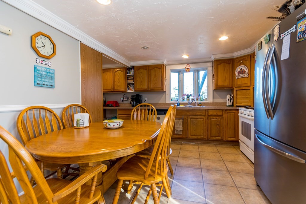 16 Blueberry Road Bourne, MA 02532 - Photo 7 of 22 a kitchen with stainless steel appliances granite countertop a dining table and chairs