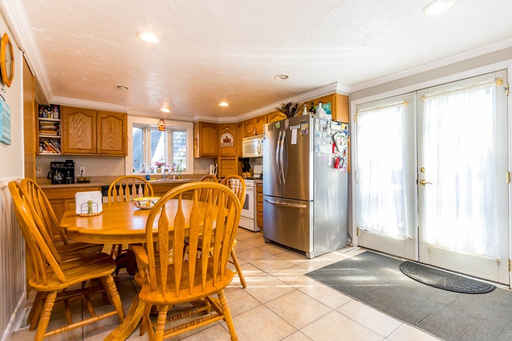 16 Blueberry Road Bourne, MA 02532 - Photo 8 of 22 a dinning area with stainless steel appliances a refrigerator and a table