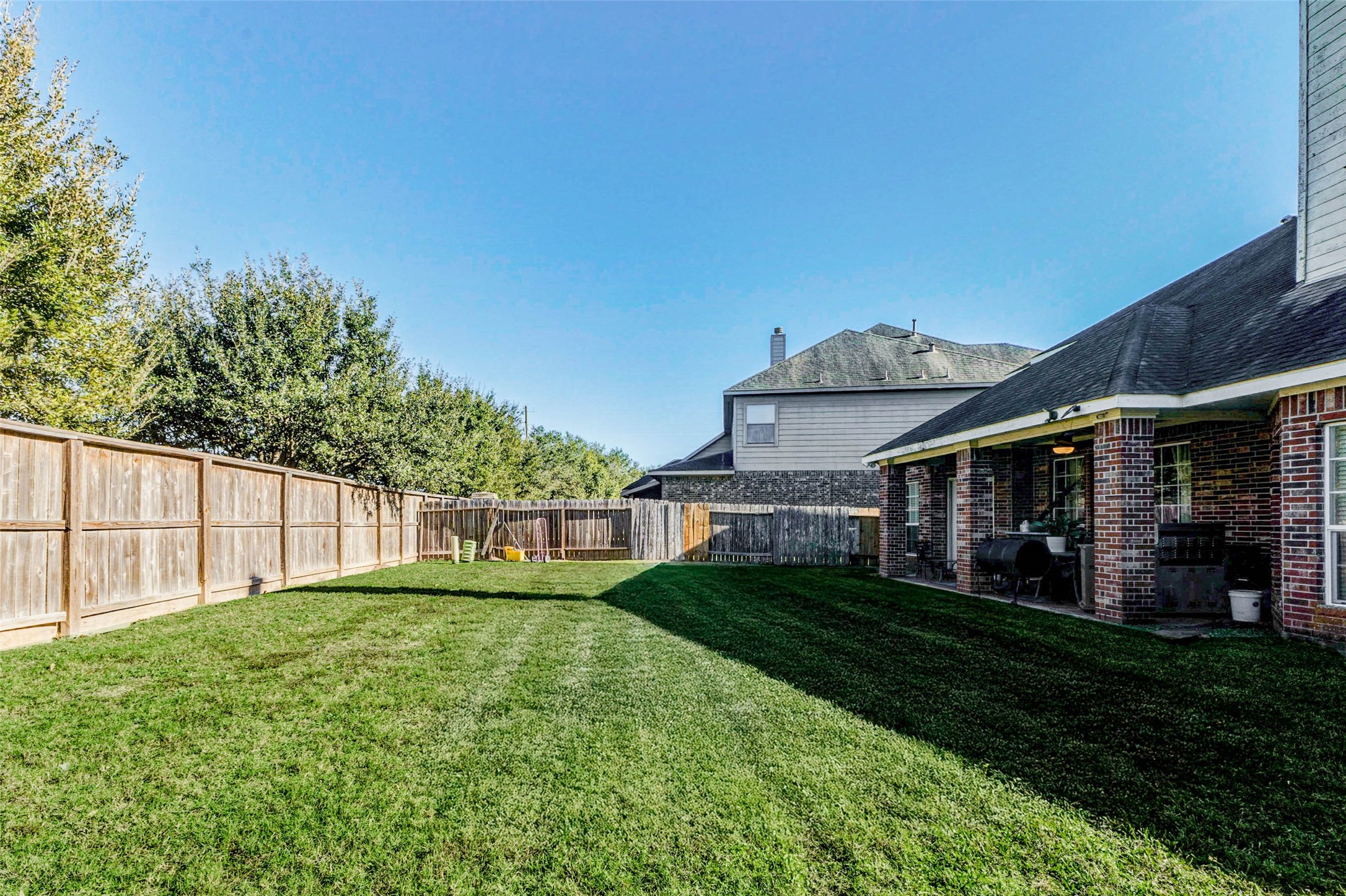 8211 Paddle Rock Lane Rosenberg, TX 77469 - Photo 48 of 50 a view of a house with a yard and plants