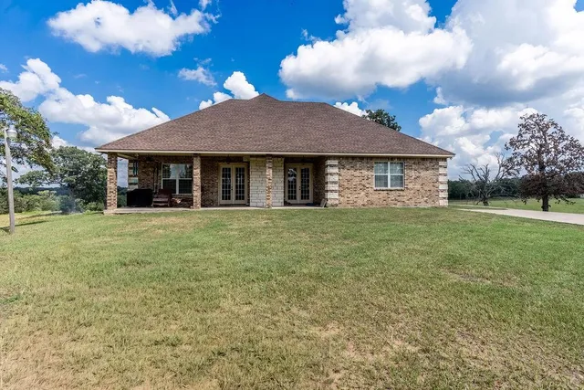a view of a big yard with swimming pool and green space