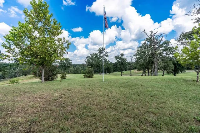 a view of an empty room with cabinet and a window