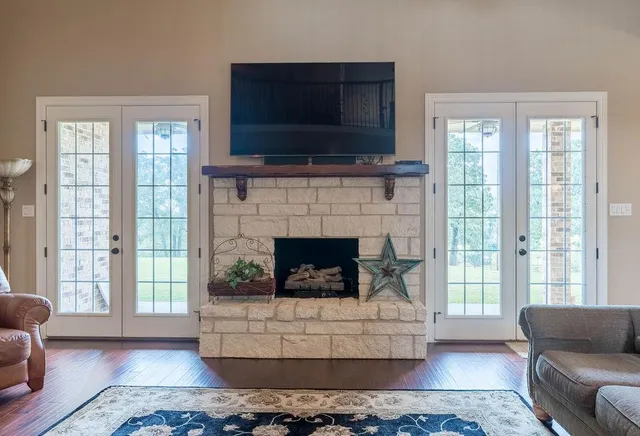a living room with furniture a flat screen tv and a fireplace