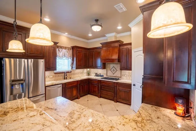 a kitchen with granite countertop a sink and a stove