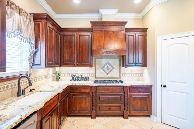 a kitchen with granite countertop stainless steel appliances and wooden cabinets