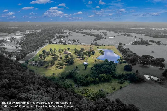 an aerial view of a residential houses with outdoor space