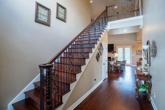a view of entryway and hall with wooden floor