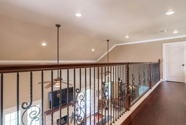 a view of a hallway with wooden floor