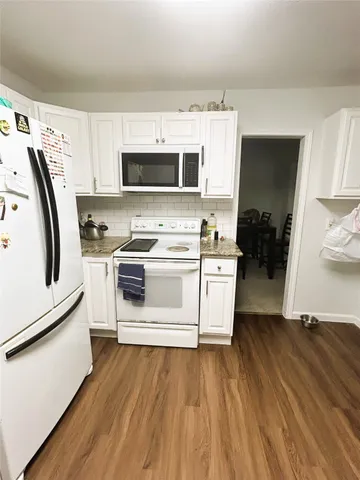 a kitchen with stainless steel appliances a stove a sink and a refrigerator