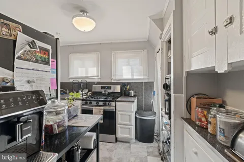 a kitchen with a stove and a refrigerator