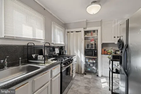 a kitchen with stainless steel appliances a refrigerator sink and stove